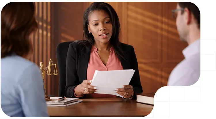 A lawyer reviewing documents with clients regarding the procedural efficiency law.