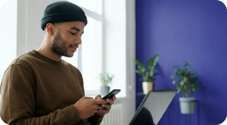 A young professional managing automated business processes through their smartphone.