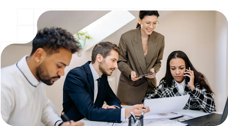 Team reviewing documents in a work meeting