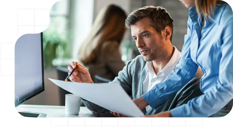 Professional consultants reviewing documents and analyzing strategic information in an office, as part of a business advisory and decision-making service