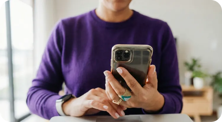 Person using a mobile phone with a login screen.